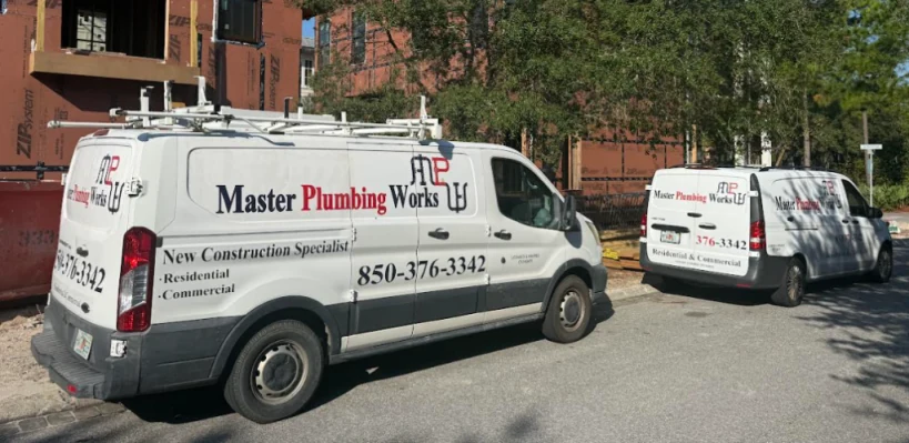 Master Plumbing Works service van on a new construction job site in Santa Rosa Beach, FL